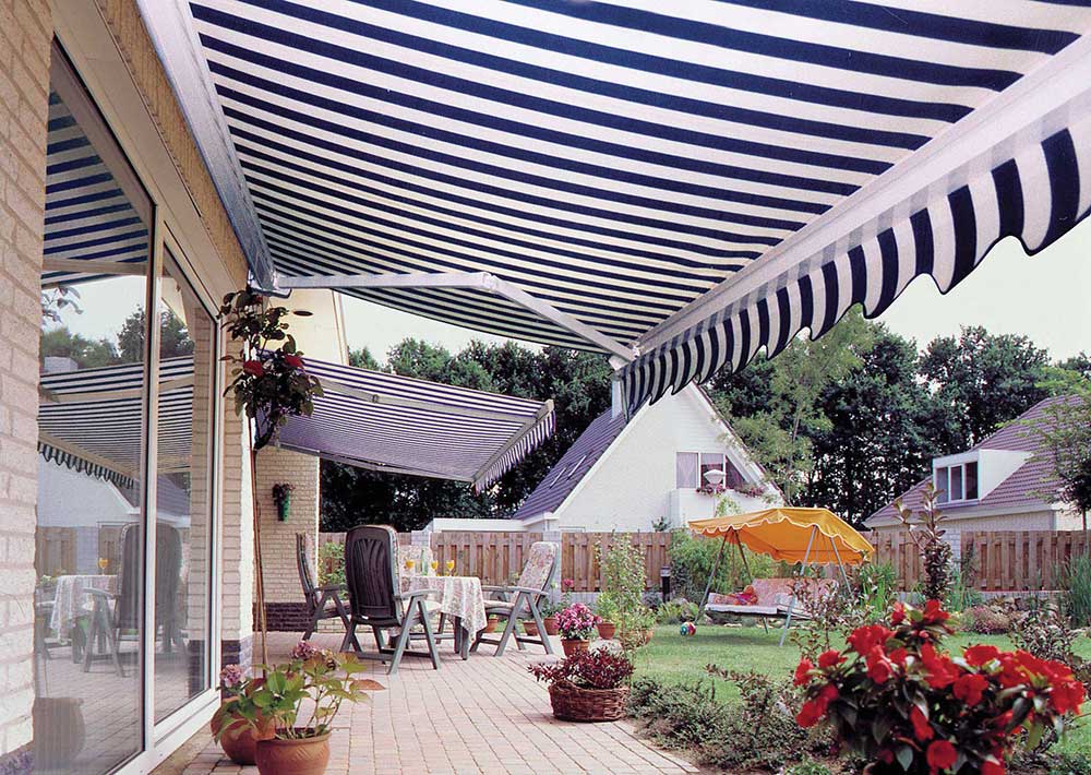 Retractable blue and white awning installed over Norfolk garden.