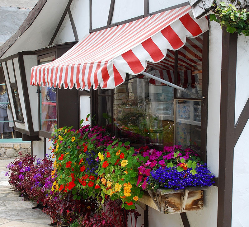 Red and white striped awning over shop window