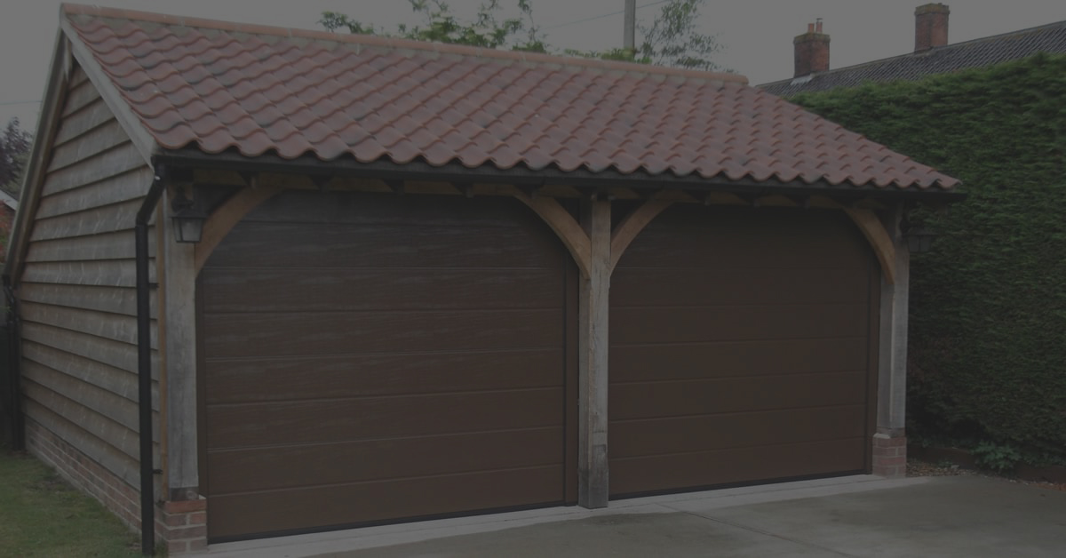 Double tilt up brown garage doors installed in a Suffolk property.