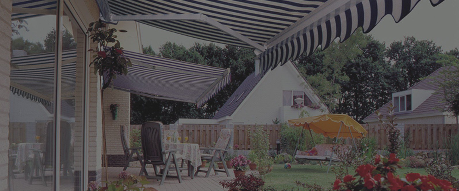 Blue and white striped electrically operated awning in a Norfolk garden